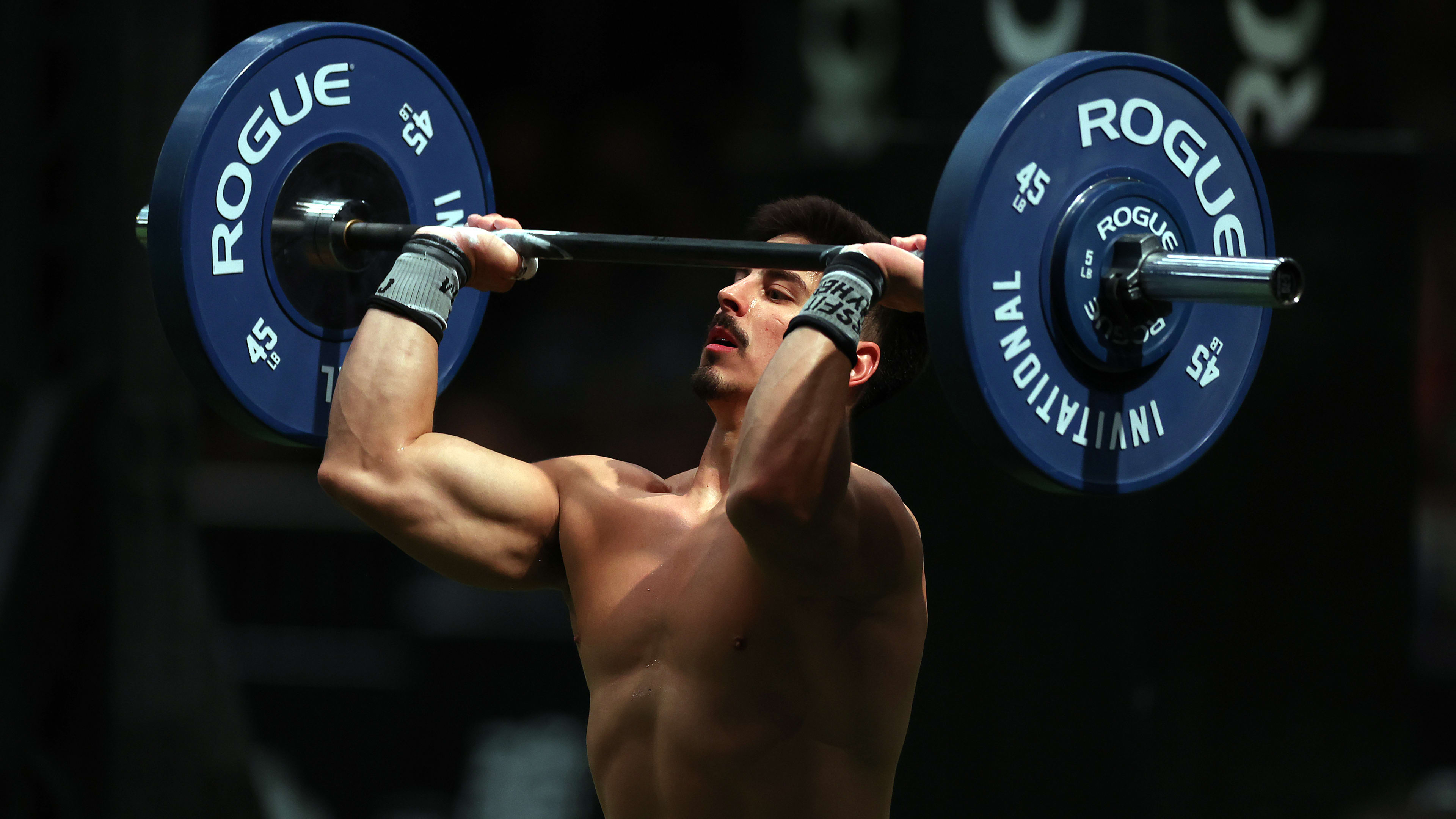 CrossFit Games champion performing a dumbbell snatch