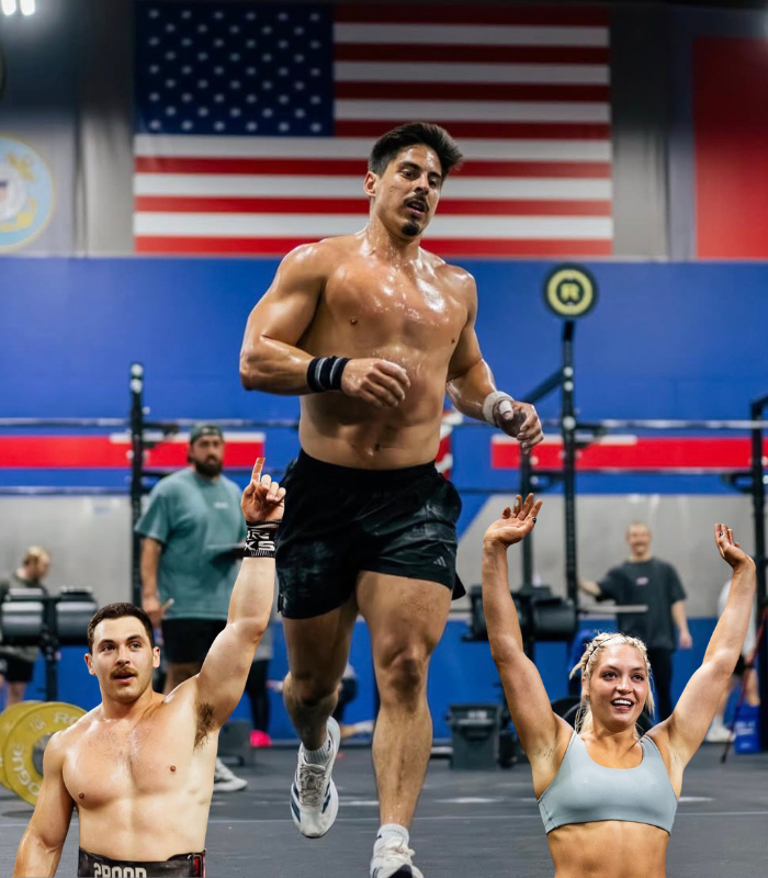 CrossFit athletes walking through a venue as coaching camps shuffle